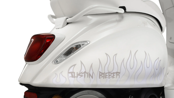 The rear end of a Justin Bieber Vespa X Sprint scooter