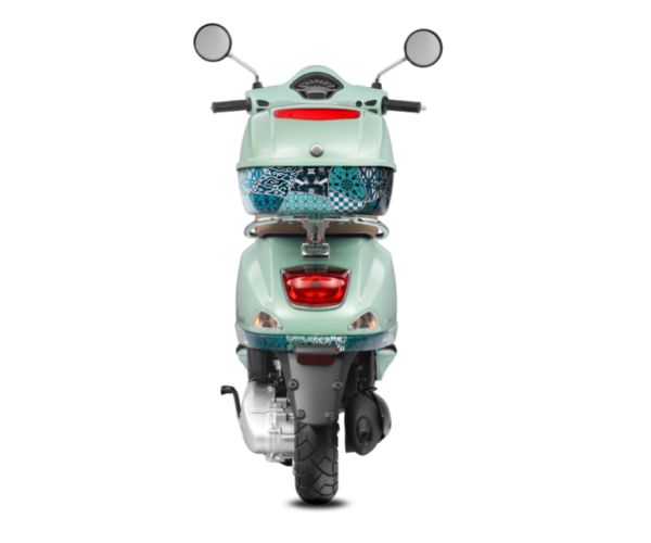 Rear view of a mint green retro-style motor scooter with a patterned seat cover, visible tail light, and rearview mirrors, isolated on a white background.