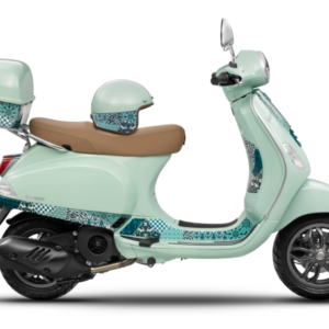 A mint green scooter with patterned detailing, a matching helmet, and a tan seat, displayed in profile view against a white background.