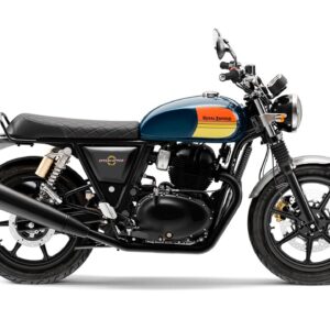 Alt text: A Royal Enfield Interceptor motorcycle in a studio setting, featuring a black frame, blue and orange fuel tank, and a diamond-stitched black seat.