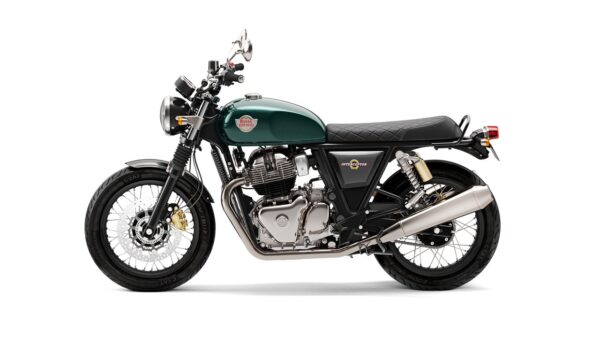 A Royal Enfield Interceptor motorcycle with a green fuel tank and black seat positioned against a white background.