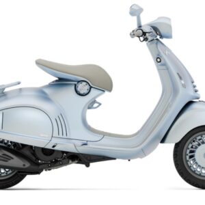 Vespa 946 Snake A light blue vintage-style scooter with a rounded design, featuring a beige seat and detailed wheel rims, positioned on a white background.