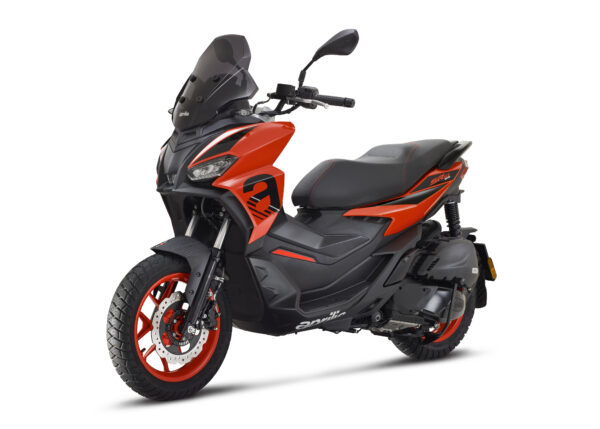 A vibrant orange and black scooter with a sporty design, featuring a windshield, bold graphics, and red accents on the wheels. The scooter is positioned at an angle, showcasing its side profile, seat, and front wheel.