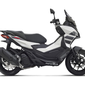 A sleek, modern scooter in white and black, featuring a streamlined design, a tall windshield, and sporty accents, viewed from the side. The scooter displays the brand name "aprilia" prominently on its body.