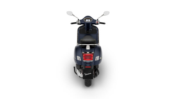 A blue scooter viewed from the rear, displaying its seat, dashboard, and rear light against a white background.