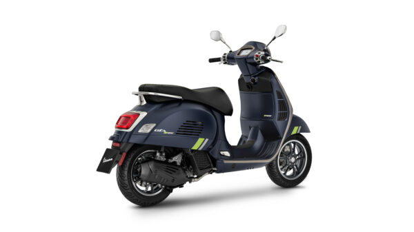 A dark blue Vespa scooter with green accents, viewed from the rear, showcasing its sleek design and chrome details.