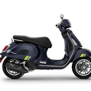Vespa GTS 125 SuperTech Euro 5+ A sleek, modern scooter in a dark blue finish with green accents, featuring a stylish design, comfortable seat, and intricate wheel detail, captured from a side perspective.
