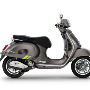 A sleek, modern gray scooter with green accents, viewed from the side, showcasing its design, wheels, and handlebars.