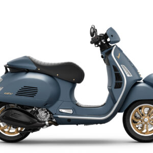 Vespa GTV 310 Officina 8 Euro 5+ A blue scooter with a retro design, featuring a black seat and gold wheels, positioned to showcase its side profile.