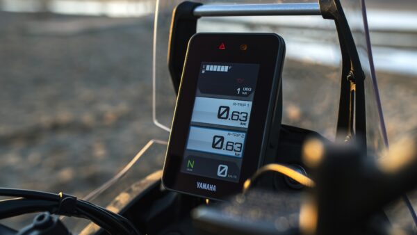 Close-up of a Yamaha motorcycle dashboard displaying various metrics including distance traveled (1 km), two trip counters (0.63 km each), and gear indicator in neutral (N).