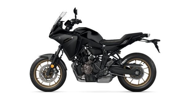 A side view of a sleek black motorcycle with gold rims and a modern design, featuring a prominent windscreen and sporty seating.