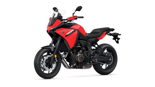 A red Yamaha Tracer 7 motorcycle is shown at a slight angle, showcasing its sporty design, dual front disc brakes, and modern features, set against a plain white background.
