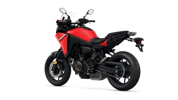 A red and black motorcycle is shown from a slightly elevated angle, highlighting its sporty design, large tires, and dual mirrors. The rear section features a sleek tail light and a robust exhaust.