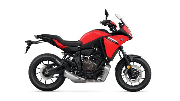 A red Yamaha Tracer 7 motorcycle is displayed from the side, showcasing its sleek design, modern features, and sporty tires against a white background.