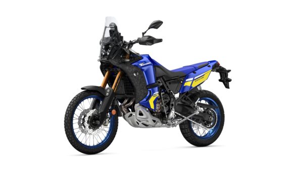 A blue and black adventure motorcycle with dual-sport tires, featuring gold front forks and distinctive yellow graphics.