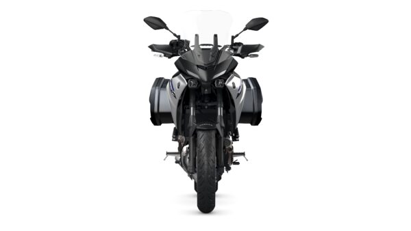 A front view of a sleek, modern motorcycle with a black and silver color scheme, equipped with side panniers and a tall windshield.