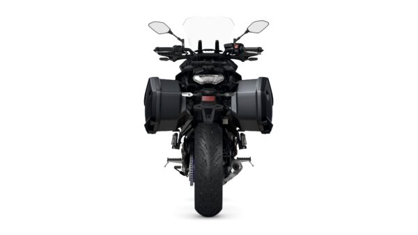 A black motorcycle viewed from the front, featuring large side panniers, a windshield, and a detailed tire design.