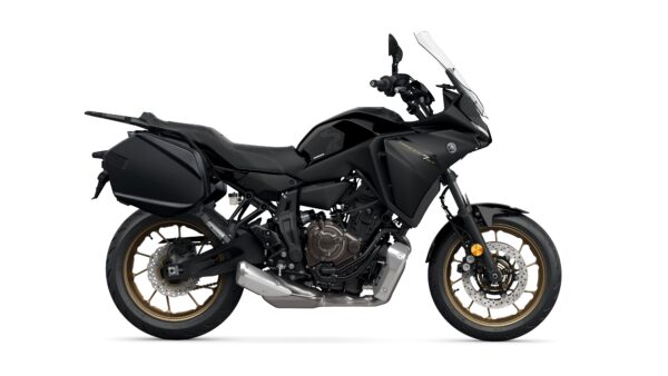 A sleek black motorcycle with gold wheels and a modern design, featuring a windscreen, side panniers, and a prominent engine.