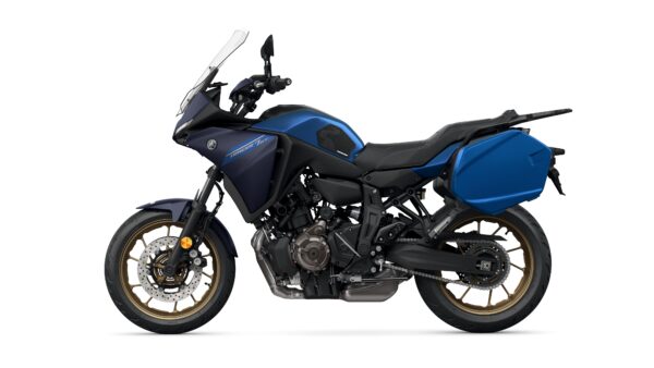 A blue Yamaha motorcycle with a sleek design, featuring a touring-style windscreen, black seat, and gold-accented wheels. It has side panniers and an engine exposed for visibility, positioned on a white background.