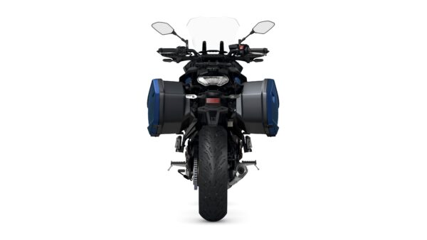 Front view of a motorcycle equipped with side panniers, showcasing the tire and chassis details against a white background.