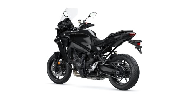 A sleek black motorcycle viewed from the rear, showcasing its modern design, features such as a windscreen, dual exhaust, and sporty tires.