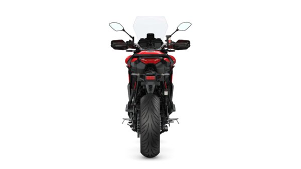 A red and black motorcycle viewed head-on, featuring a tall windscreen, dual mirrors, and a wide rear tire.