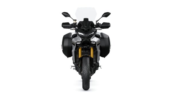 Front view of a modern motorcycle with a black and silver design, featuring side panniers, a tall windshield, and distinctive dual headlights.
