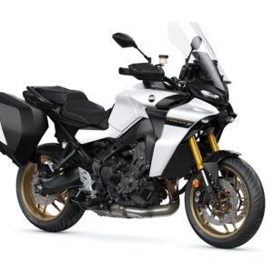 Yamaha 2024 Tracer GT A modern sport-touring motorcycle with a white and black body, featuring a tall windshield, gold forks, and saddle bags on both sides.