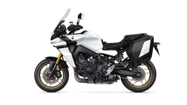A side view of a sleek, modern motorcycle with a silver and black color scheme, featuring gold wheels, a tall windshield, and saddlebags.