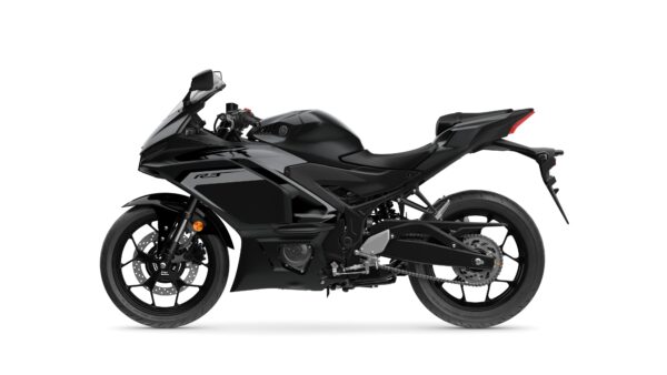 A sleek black sport motorcycle, the Yamaha YZF-R3, shown from the side with a streamlined body, sport fairings, and distinctive design elements.