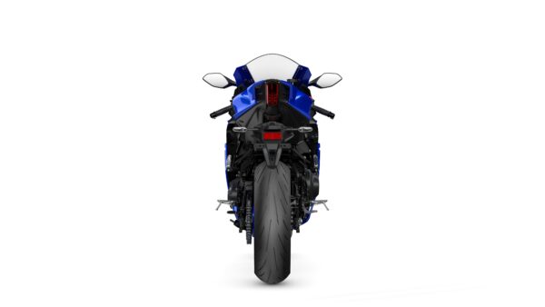 A blue sports motorcycle viewed from the rear, showcasing its sleek design, prominent rear tire, and dual exhausts.