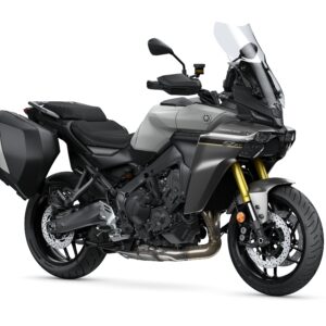 Yamaha 2025 TRACER 9 GT Y-AMT A sleek, modern motorcycle with a metallic gray body, gold front forks, and black side panniers, positioned at a slight angle to showcase its design and features.