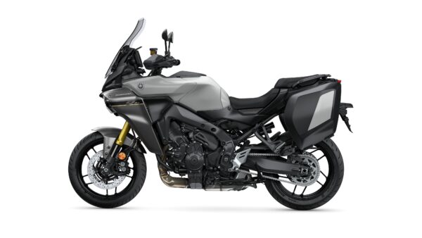 A side view of a gray Yamaha motorcycle equipped with a windshield, black seat, and hard side panniers, showcasing a sturdy design suitable for touring and adventure riding.