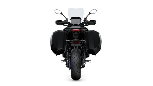 A rear view of a black motorcycle with side panniers, showcasing the tire, tail light, and mirrors. The background is plain white.