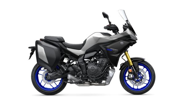 Side view of a Yamaha Tracer 7 motorcycle, featuring a sleek design with a gray and black color scheme, blue wheels, and saddlebags.