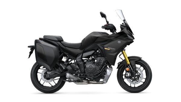 A sleek black Yamaha Tracer 7 GT motorcycle viewed from the side, featuring a sporty design, golden front shocks, and integrated luggage compartments.