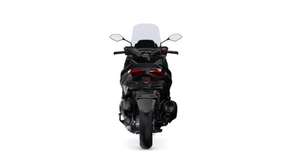 A rear view of a sleek black motorcycle with a tall windshield, featuring modern tail lights and a distinct exhaust system.