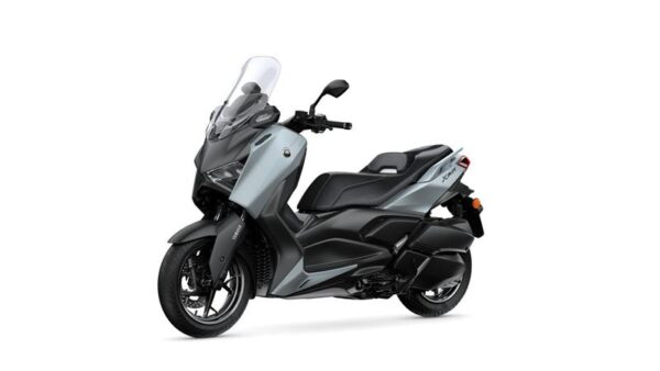 A modern gray and black scooter with a sleek design, featuring a tall windshield and comfortable seating, positioned at a slight angle against a plain white background.