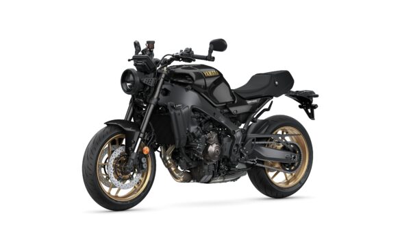 A sleek black Yamaha motorcycle with gold wheels, featuring a minimalist design, sporty frame, and an aggressive stance, positioned at a slight angle against a white background.