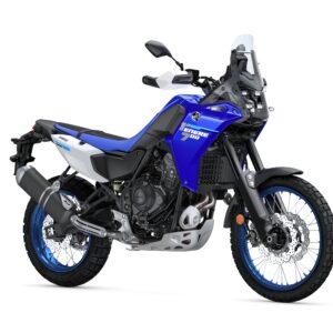 A blue and white adventure motorcycle with a rugged design, featuring wide tires, a prominent front fender, and a tall windscreen, parked on a white background.
