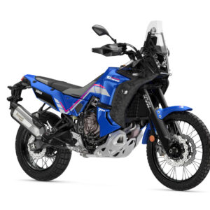 A blue Yamaha Tenere 700 motorcycle is displayed, showcasing its rugged design, front fender, and off-road tires, with a black windscreen and silver exhaust system visible.