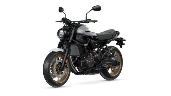 Yamaha XSR motorcycle with a modern retro design, featuring a silver and black color scheme, a round headlight, and gold alloy wheels.