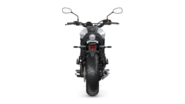 A rear view of a motorcycle showcasing its tire, exhaust, and taillight against a plain white background.