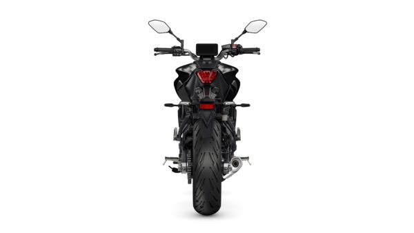 A rear view of a black motorcycle featuring a sleek design, prominent rear light, and a large rear tire. The handlebars and mirrors are visible, along with a digital instrument panel at the top.