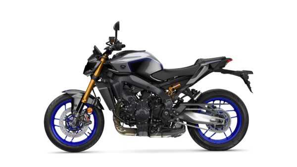 A side view of a modern sports motorcycle featuring a sleek black body with blue accents and gold front forks, showcasing its aggressive styling and design.