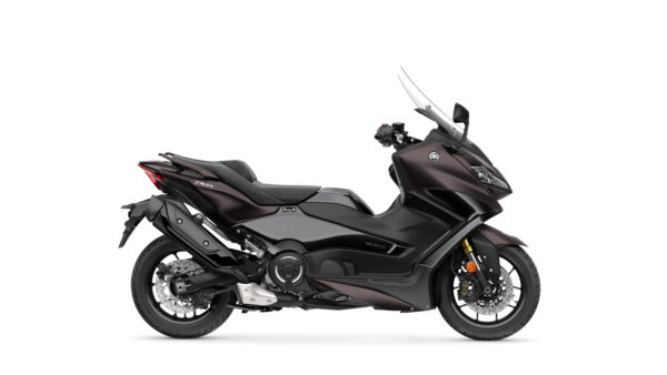 A sleek, dark gray Yamaha TMAX scooter with a sporty design, featuring a large windscreen, dual headlights, and a comfortable seat. The scooter is shown from the side, highlighting its smooth curves and modern aesthetics.