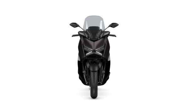Front view of a sleek, modern motorcycle with a dark color scheme and prominent windscreen, showcasing its sharp headlights and distinctive design.