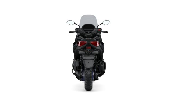 A black motorcycle viewed from the rear, showcasing its sleek design, dual taillights, and a large windshield.