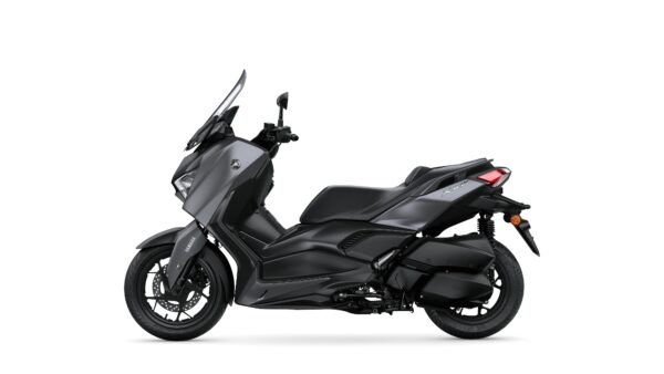 A sleek black scooter, the Yamaha XMAX, is displayed in profile against a white background, showcasing its streamlined design and modern features.