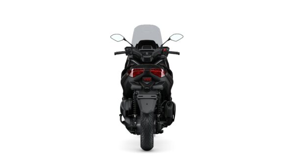 A rear view of a black motorcycle featuring dual red tail lights, mirrors, and a large windscreen.